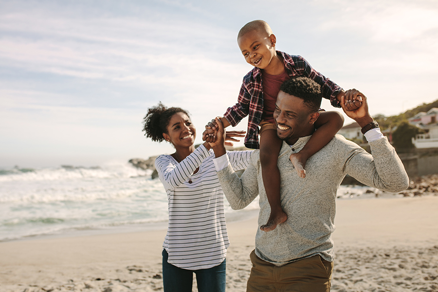 Personal Insurance - Parents Carrying Son on Shoulders on Beach Vacation in Fort Lauderdale, Florida
